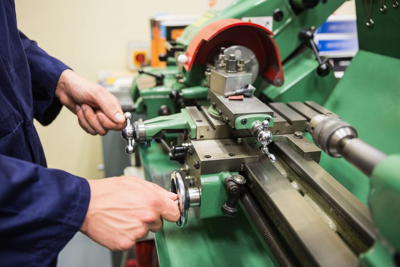 Engineering student using heavy machinery at the university