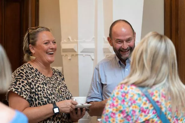 adults smiling whilst networking at event