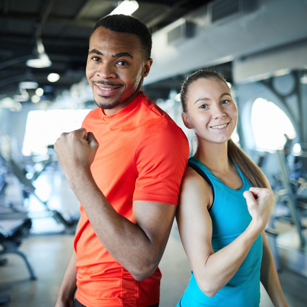 male and female in gym posing